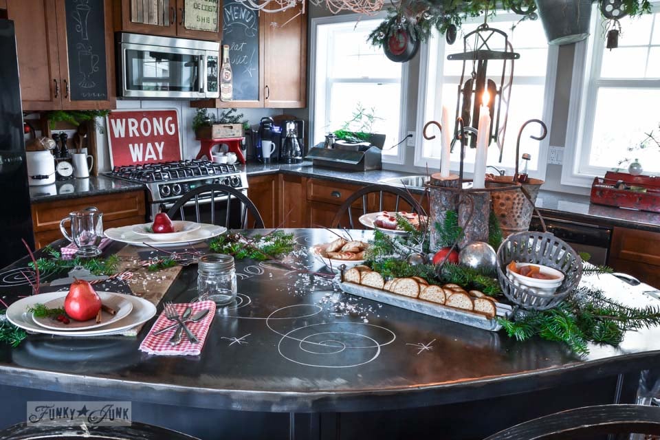 Black metal kitchen island decked out with Christmas food / A junky Christmas kitchen / salvaged finds used to deck out this kitchen for Christmas via https://www.funkyjunkinteriors.net/ Black metal kitchen island decked out with Christmas food / A junky Christmas kitchen / salvaged finds used to deck out this kitchen for Christmas via https://www.funkyjunkinteriors.net/