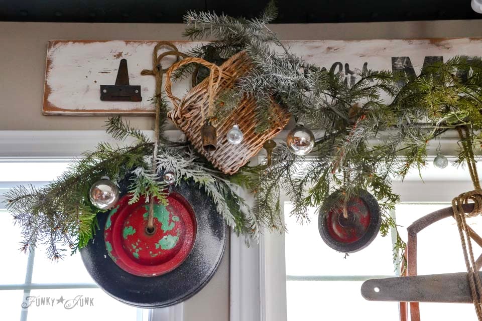 Christmas junk wheel wreath valance / A well lit junky Christmas kitchen / salvaged finds used to deck out this kitchen for Christmas via https://www.funkyjunkinteriors.net/ Christmas junk wheel wreath valance / A well lit junky Christmas kitchen / salvaged finds used to deck out this kitchen for Christmas via https://www.funkyjunkinteriors.net/