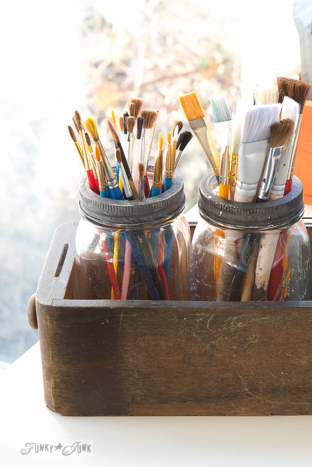 Mason jars in a drawer paint brush storage / Tips on designing an old sign themed paint studio on FunkyJunkInteriors.net