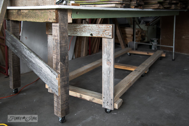 Wood storage cart under a farm table workbenchFunky Junk Interiors