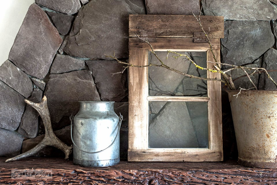 tone on tone decorating, with a moody winter mantel of branches, antlers an old window and galvanized buckets / funkyjunkinteriors.net