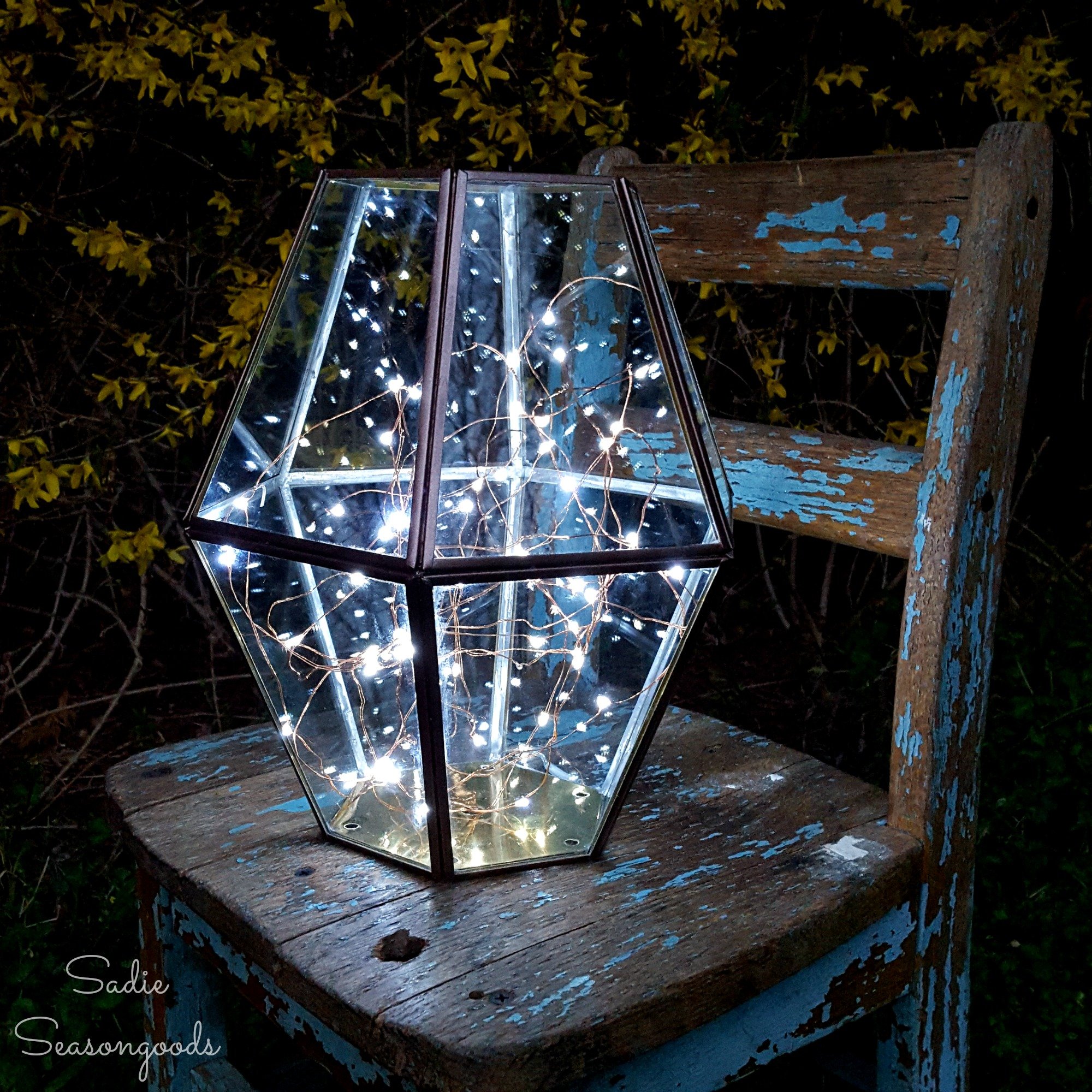 Illuminated firefly like hurricane lantern, by Sadie Seasongoods, featured on Funky Junk Interiors