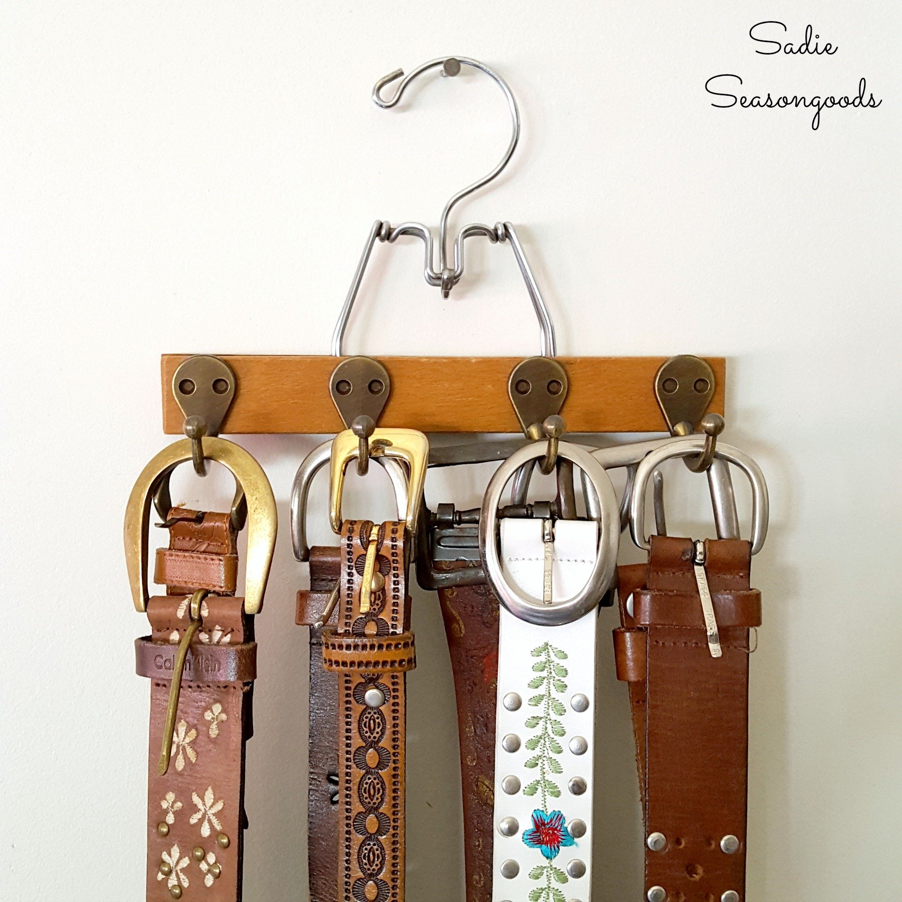 Vintage pant hanger turned belt organizer, by Sadie Seasongoods, featured on Funky Junk Interiors