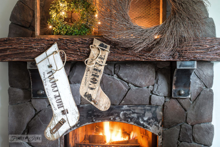 Old sign styled reclaimed wood Christmas stockings on a wreath filled