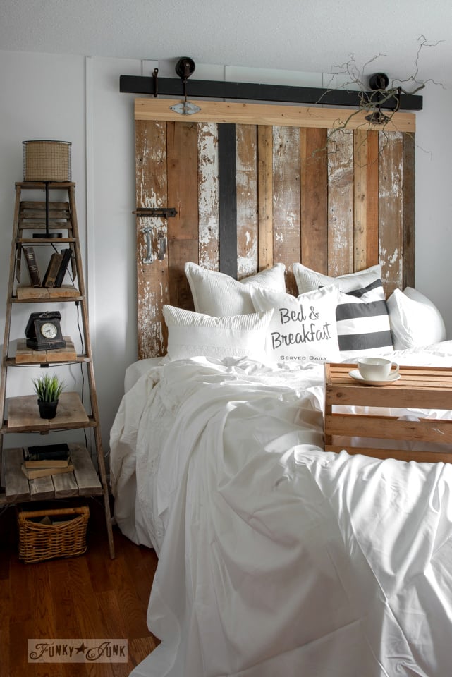 A cheater reclaimed wood barn door headboard with faux
