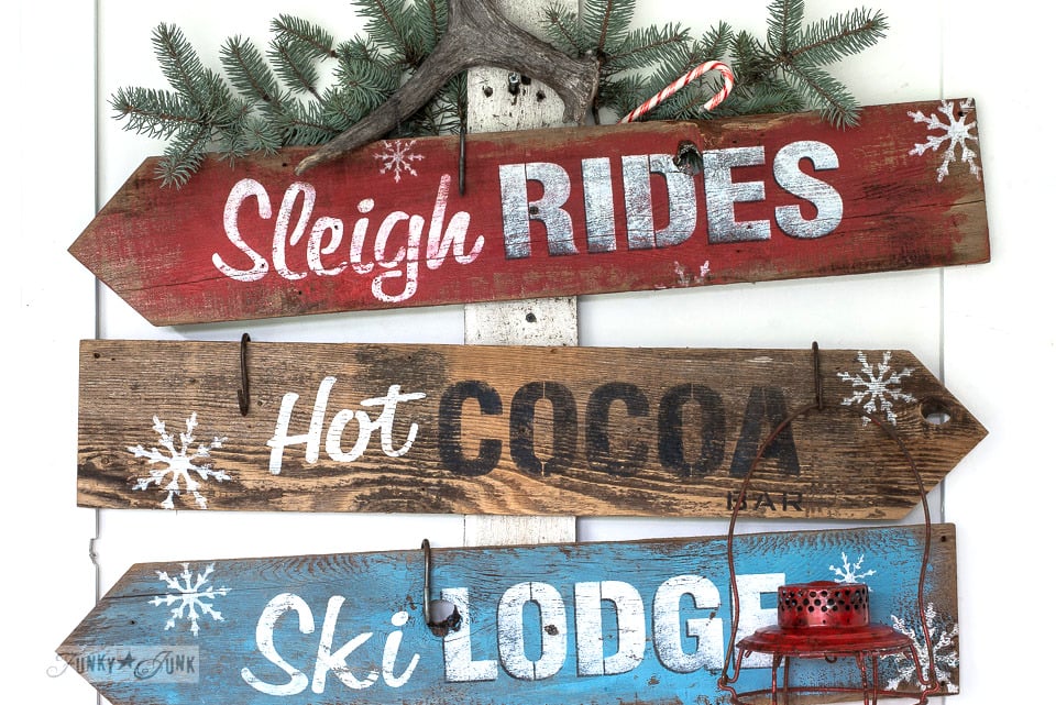 Super festive and fun Christmas and winter directional signs using stencils and reclaimed wood planks! Made with Funky Junk's Old Sign Stencils Sleigh Rides, Hot Cocoa and Ski Lodge, and Fusion Mineral Paint. Click here for the tutorial on funkyjunkinteriors.net