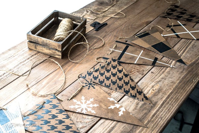 Create this cardboard stenciled banner that resembles leather, using Funky Junk's Old Sign Stencils Buffalo Check, Houndstooth, Plaid Shirt and snowflakes, with Fusion Mineral Paint