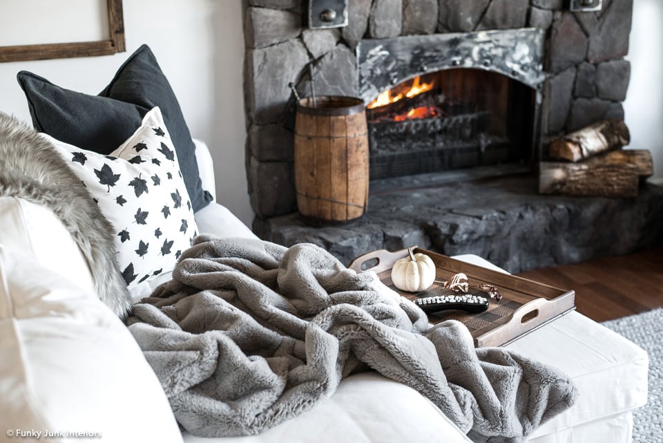a cozy blanket leaf pillow and fireplace for fall Funky Junk