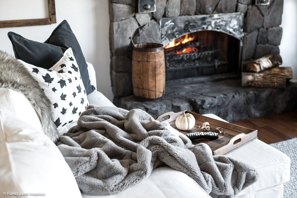 a cozy blanket, leaf pillow and fireplace for fall - Funky Junk