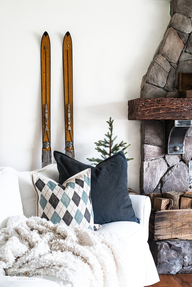 a cozy blanket, leaf pillow and fireplace for fall - Funky Junk Interiors