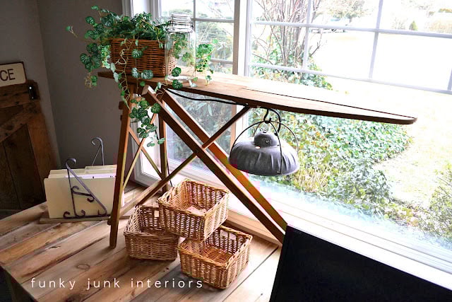 A vintage ironing board hooked up with a barn light becomes a cool farmhouse light for a rustic office desk!