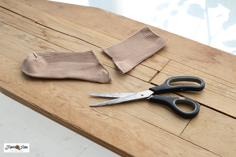 cutting a sock to make a fabric pumpkin