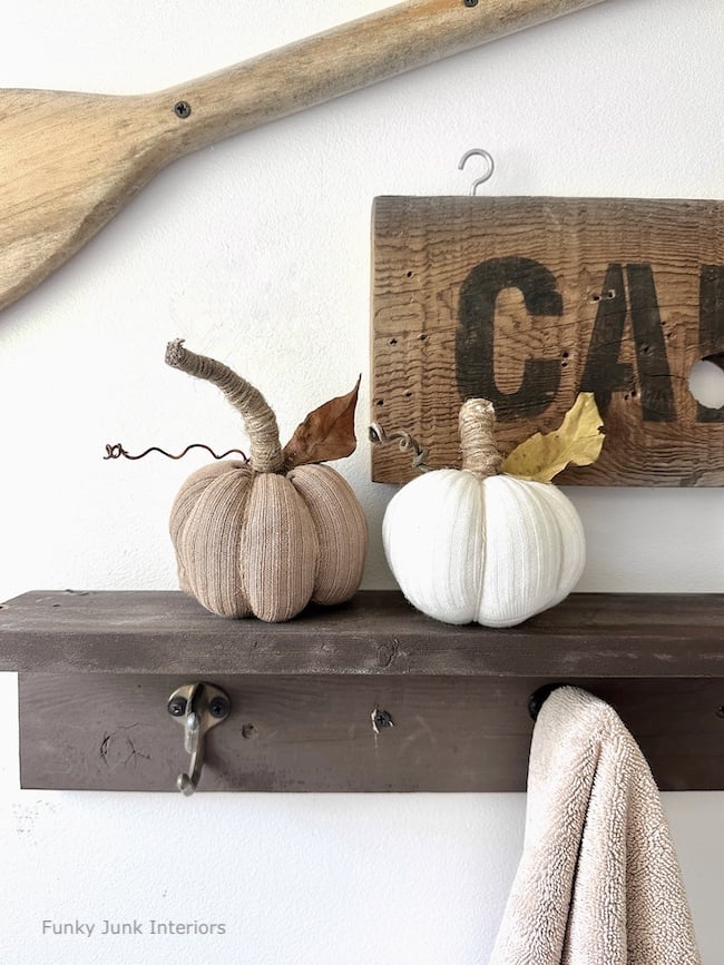 fabric pumpkins made from socks sitting on shelf