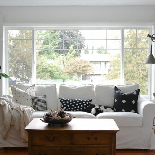 white ikea sofa in front of large picture window