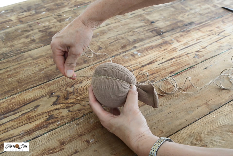 wrapping a stuffed sock with twine