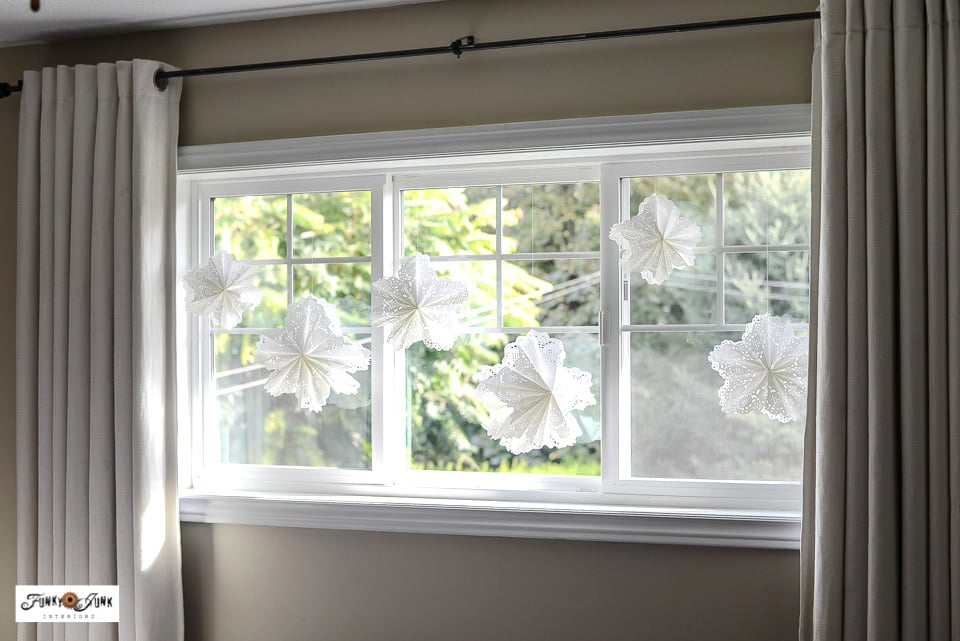 paper doily snowflakes hanging on display