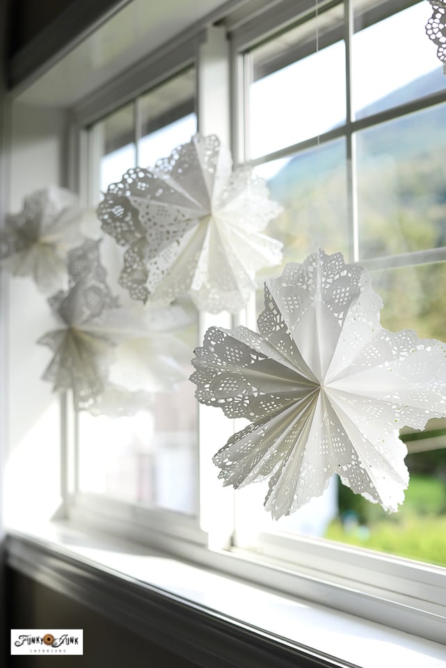 paper doily snowflakes hanging on display