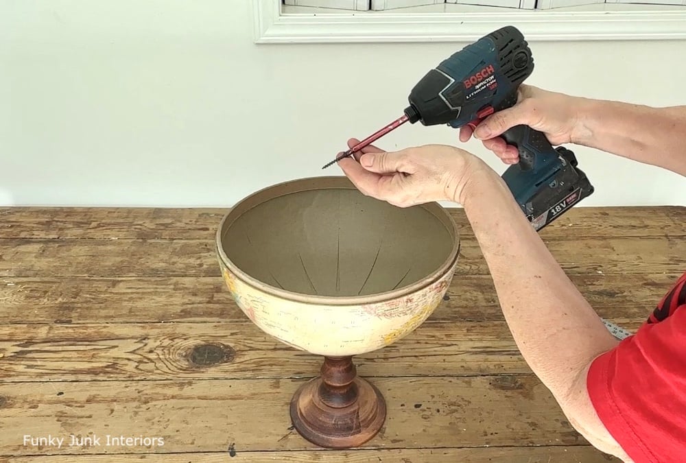 attaching an upcycled globe to a wood pedestal