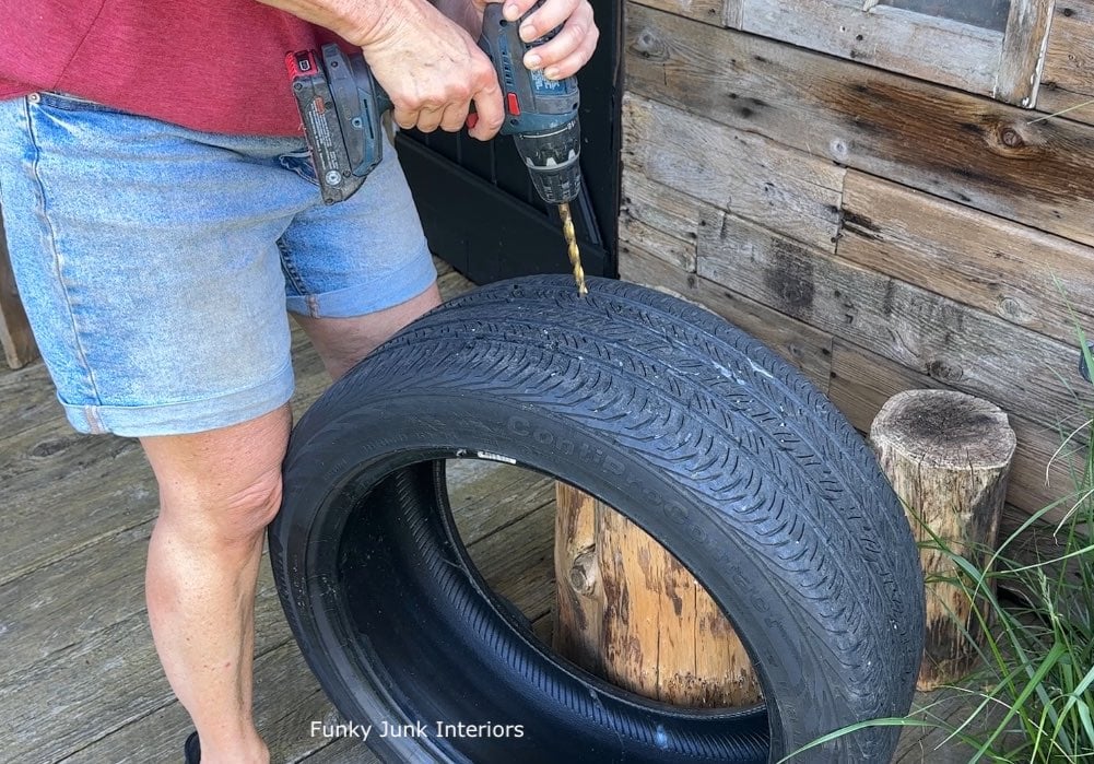 drilling holes into a tire for a tire window box planter