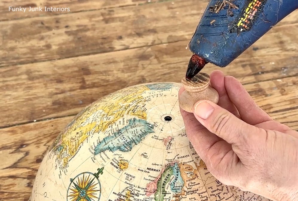 gluing a wood knob onto an upcycled globe cloche