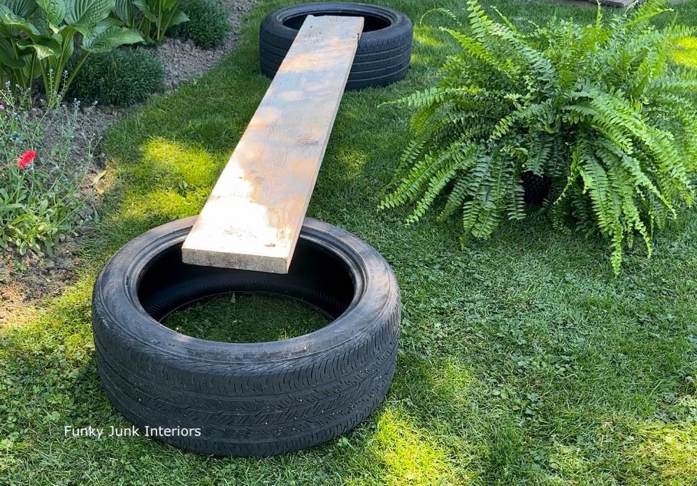 positioning a plank on tires to create a tire bench