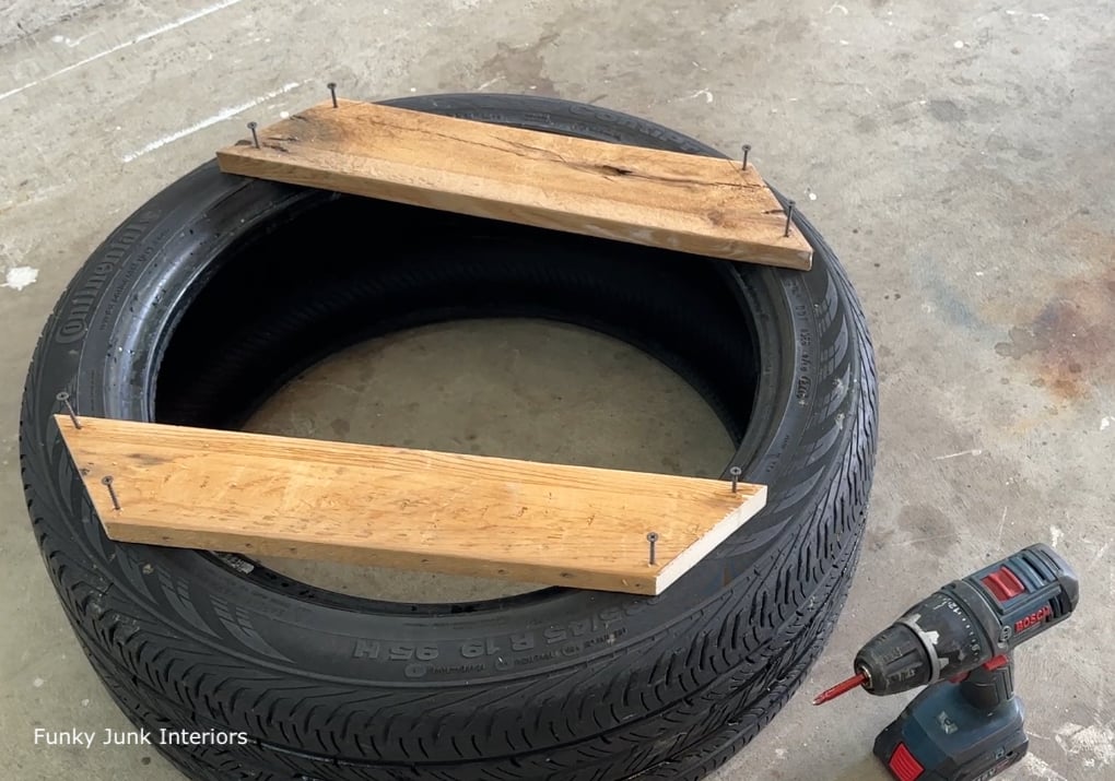 things made with used tires - attaching wood to a tire to make an ottoman