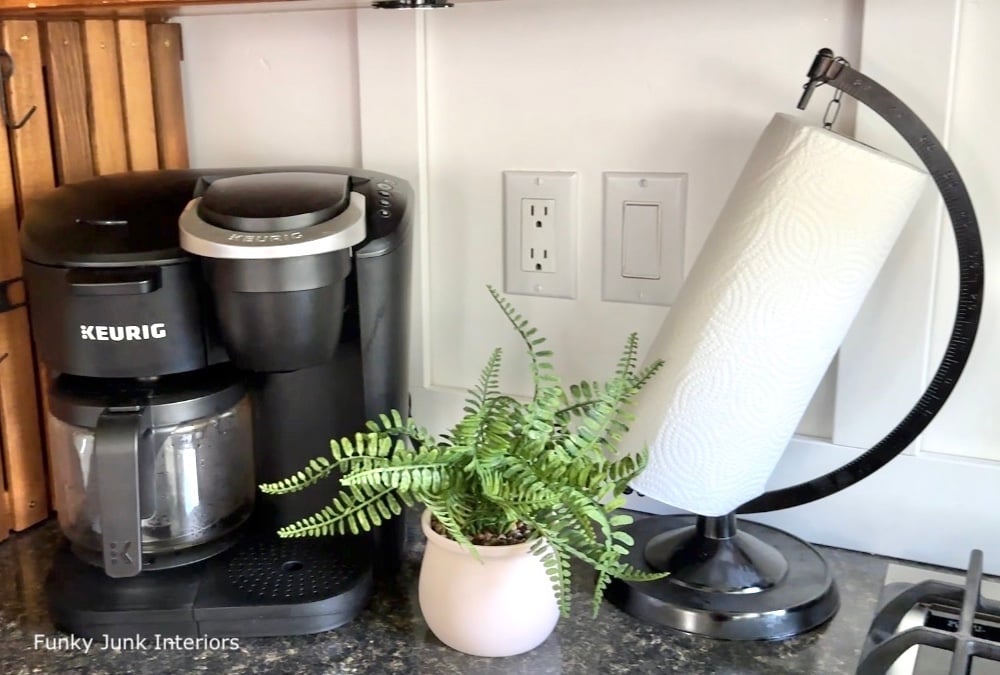 black upcycled globe paper towel stand in a kitchen