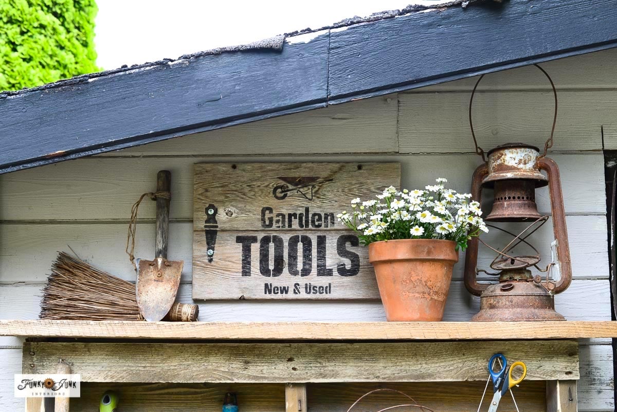 Rustic garden tools sign on top of a pallet yard tool organizer