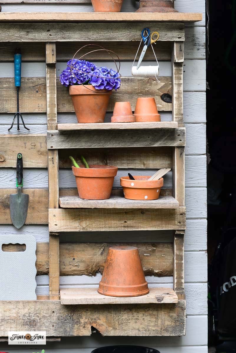 clay pots on a shelf on a pallet yard tool organizer