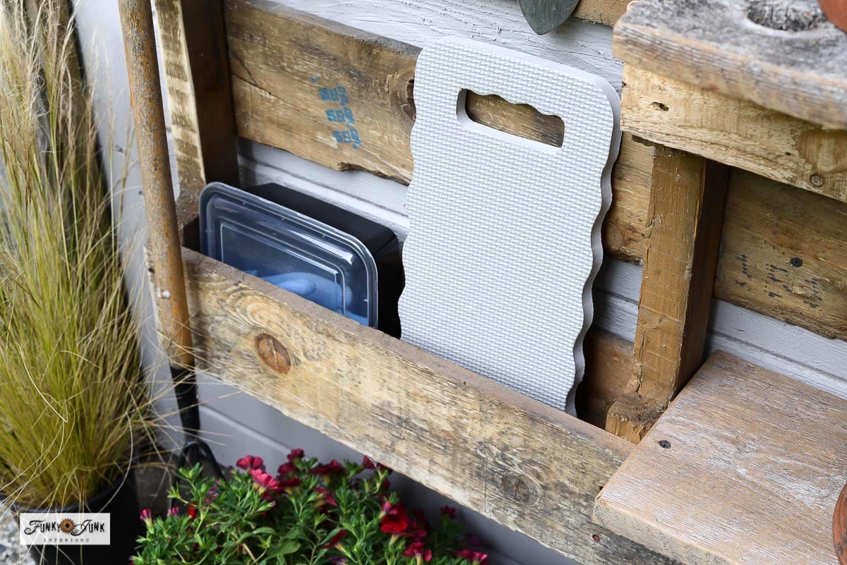garden knee pad and gloves in a pallet yard tool organizer cubby