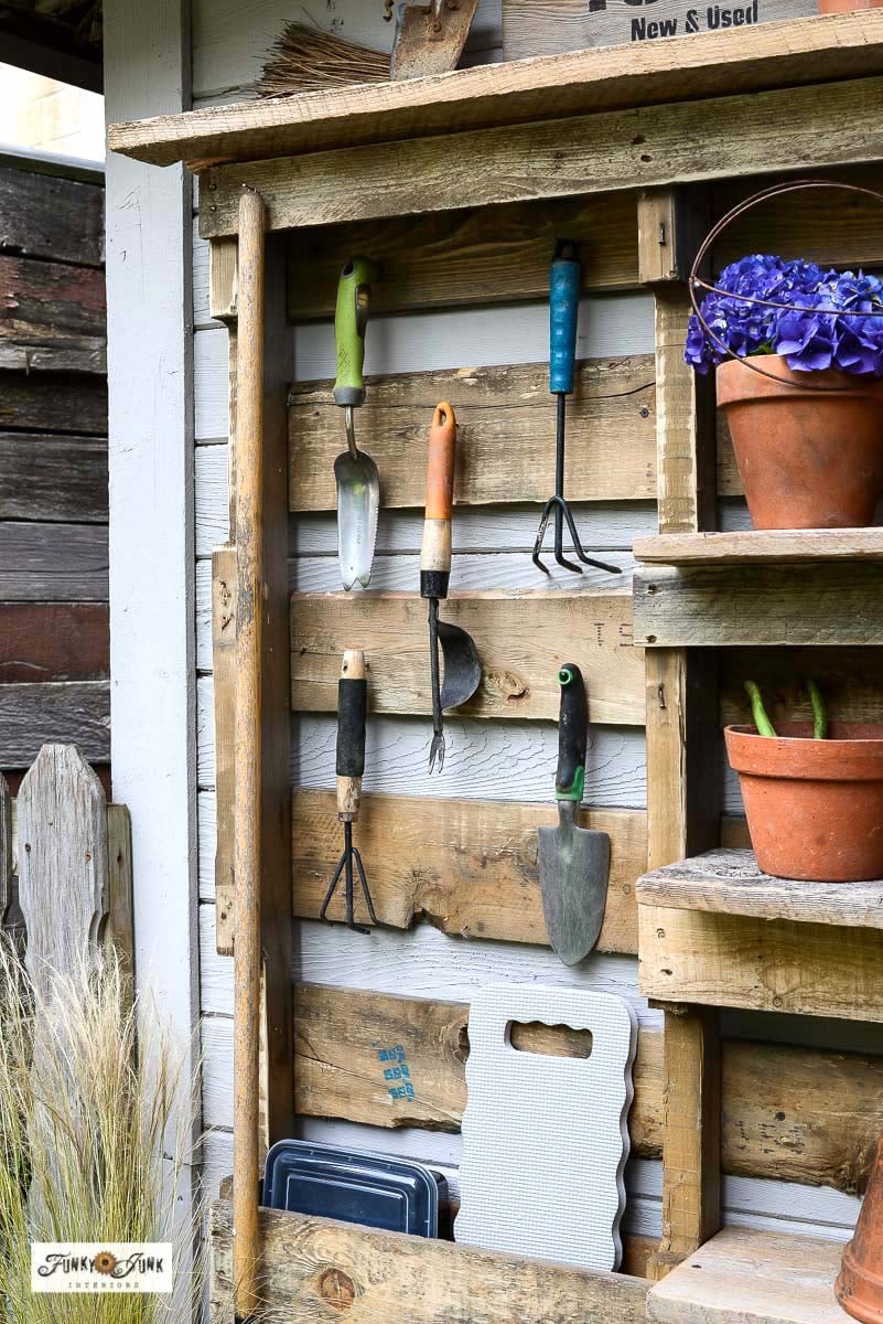hand garden tools hanging on a pallet yard tool organizer