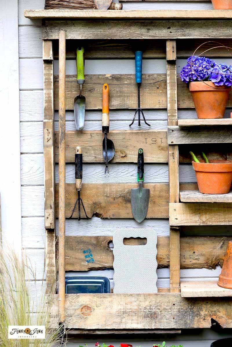 hanging hand garden tools on a pallet yard tool organizer
