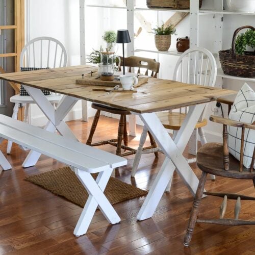 farmhouse dining table made from a picnic table painted white with a reclaimed wood top