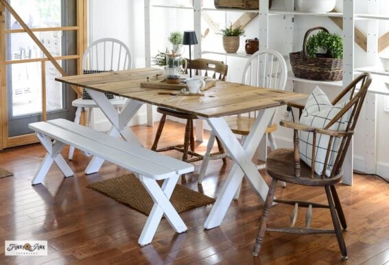 farmhouse dining table made from a picnic table painted white with a reclaimed wood top