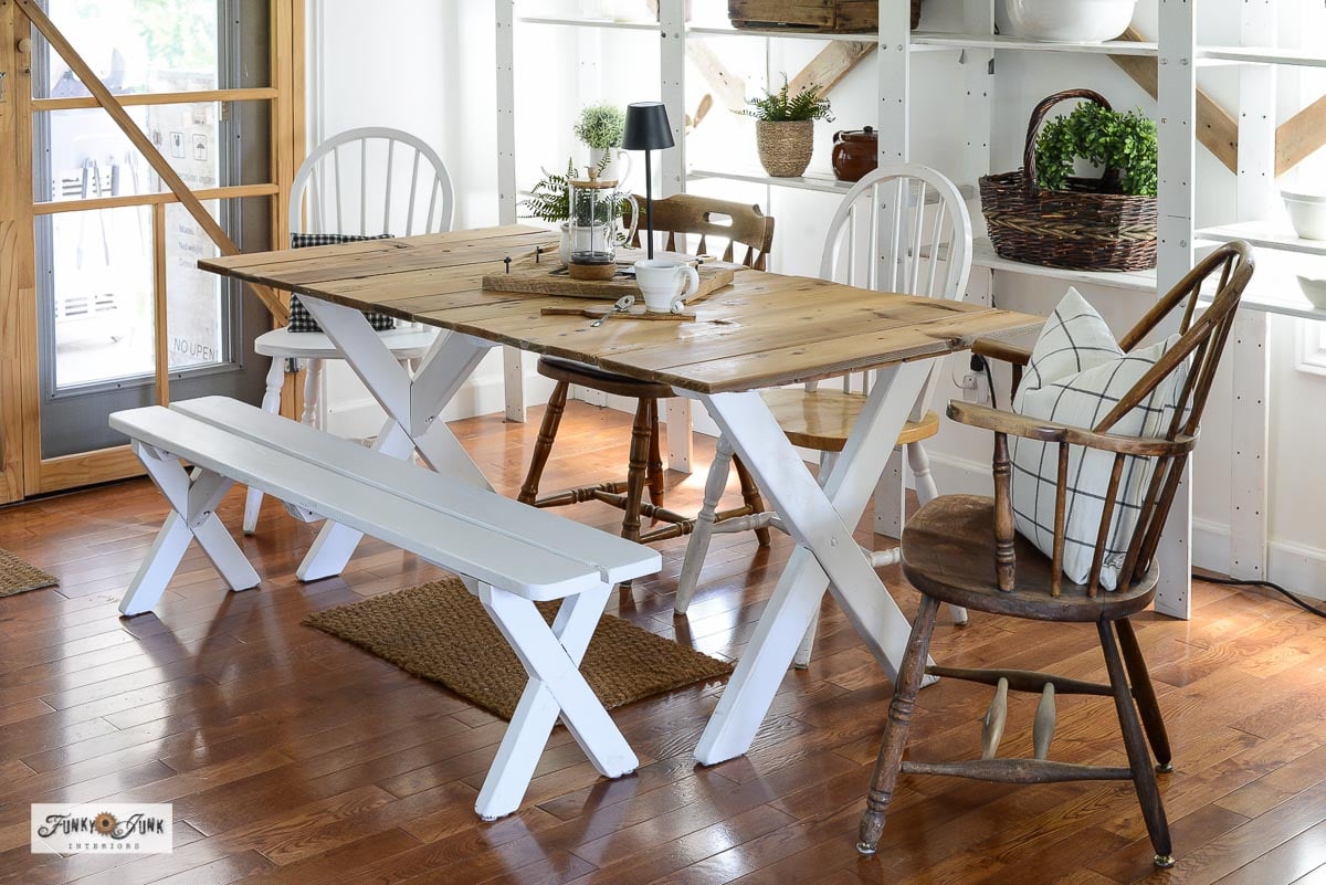 farmhouse dining table made from a picnic table painted white with a reclaimed wood top