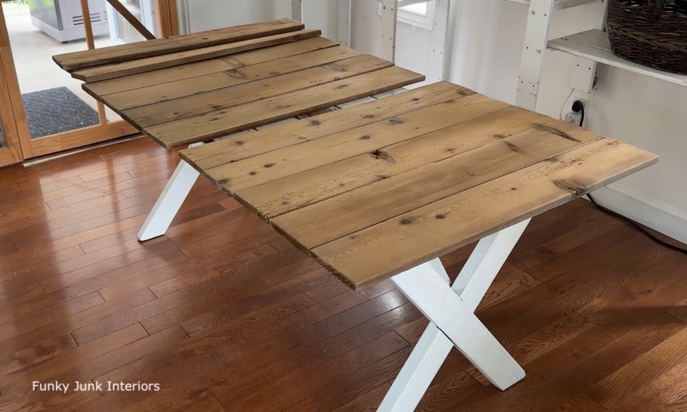 farmhouse dining table topped with reclaimed wood planks