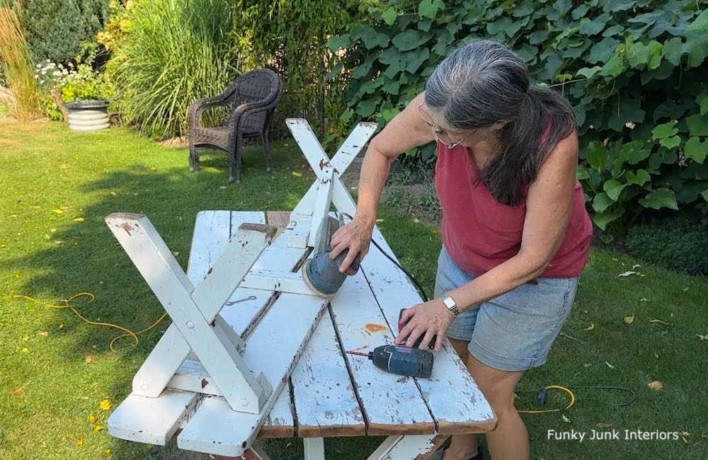 repairing and sanding an old picnic table to become a farmhouse dining table