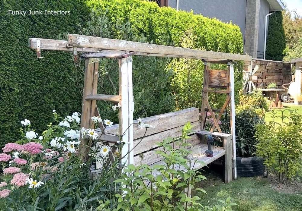 2 a-frame ladders attached to a flat ladder for a garden arbor