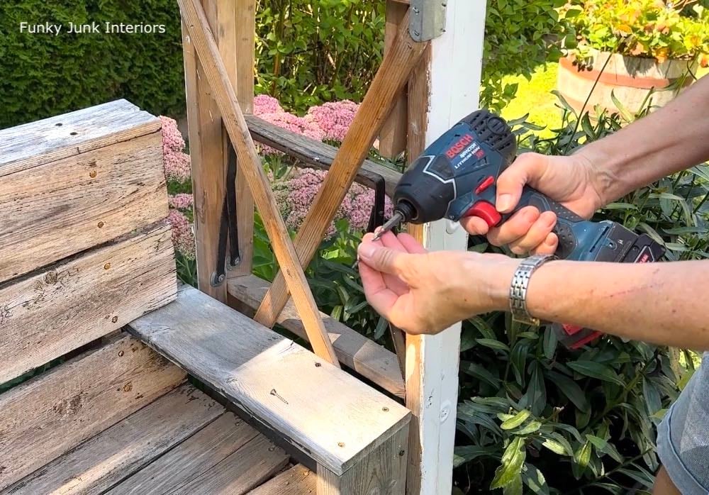 Attaching a ladder to a bench to create a garden arbor