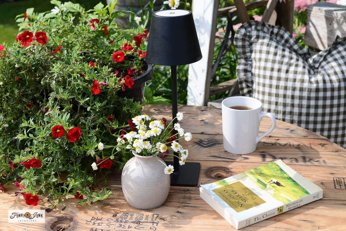 cable reel outdoor table beside a ladder garden arbor