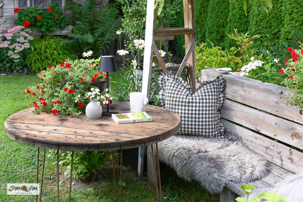 cozy bench with ladder garden arbor and outdoor reel table