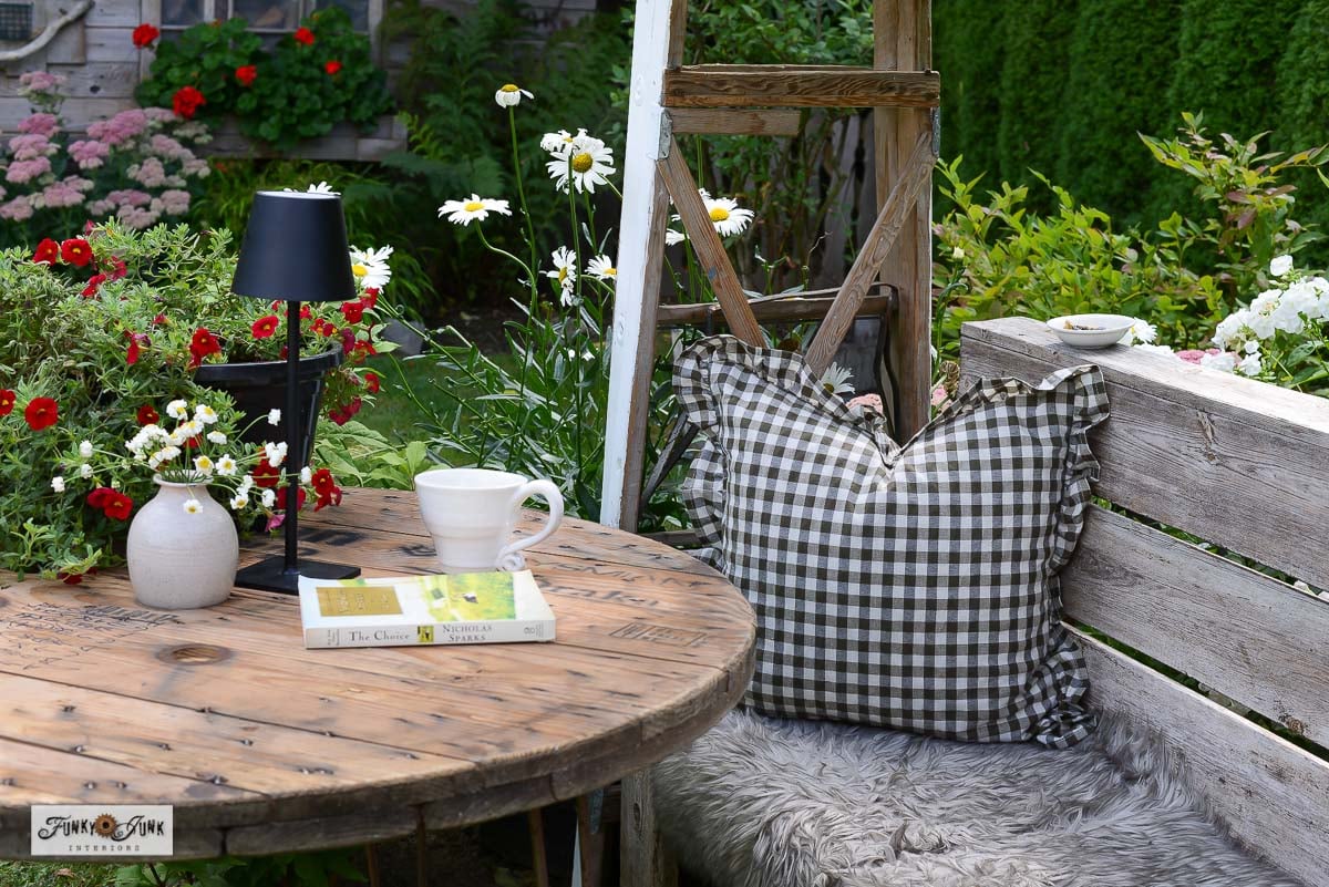 cozy nook under a ladder garden arbor with table and bench