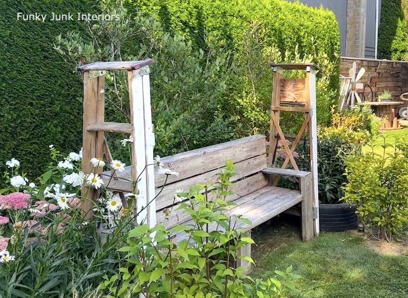 two a-frame ladders against a bench to build a DIY arbor