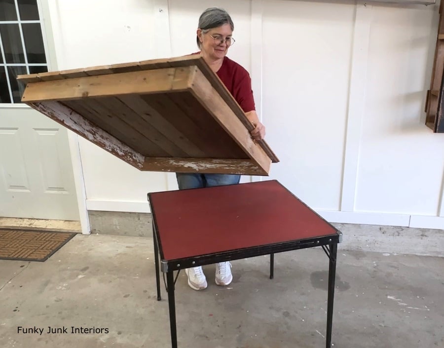lifting the wood table top off the card table