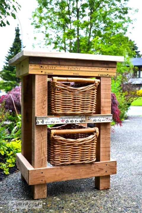 pallet wood night table with basket drawers and yardstick trim via Funky Junk Interiors