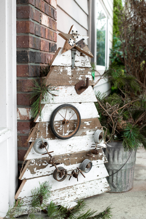 reclaimed wood Christmas tree with star standing on front porch