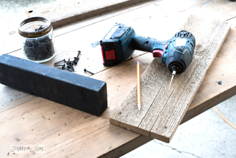 Measuring for pilot holes, part of building a DIY reclaimed wood rustic crate with Apple Farm and Flower from Funky Junk's Old Sign Stencils