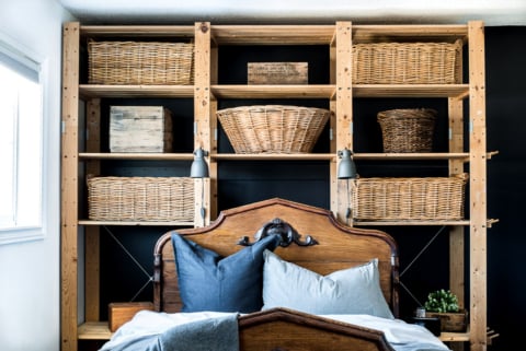 Antique bed with wicker baskets on shelves-001