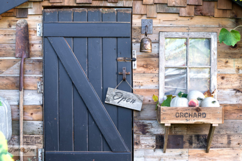 rustic fall shed with crate windowbox and directional signs