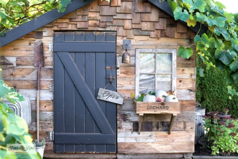 rustic fall shed with crate windowbox and directional signs